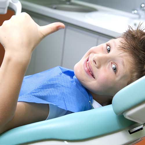 child has a cavity sitting in a dental chair